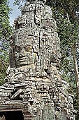 Ta Prohm temple - the temple west entrance, a well preserved gopura in the Bayon style with a tower with four faces of Lokesvara 